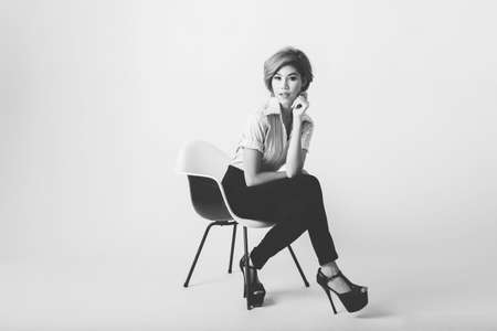 Beautiful young Asian business woman sit on the chairの写真素材