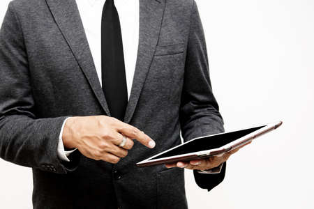 business man holding computer tablet selective focus on pointing finger