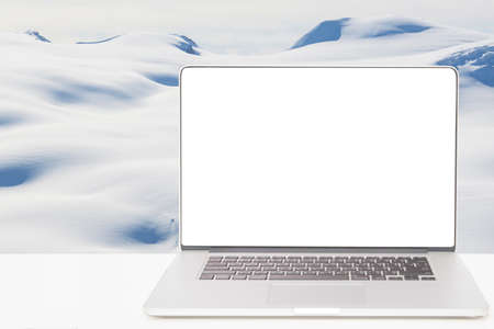 computer with white screen with snow mountainの写真素材