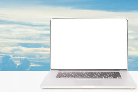computer with blank white screen on blue skyの写真素材