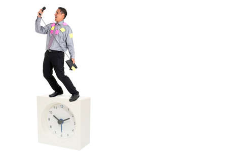 business man standing on the clockの写真素材