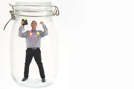 man standing inside glass bottle with telephoneの写真素材