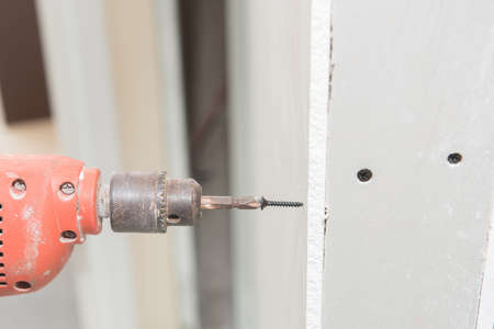 Construction worker holding the hand drillの写真素材