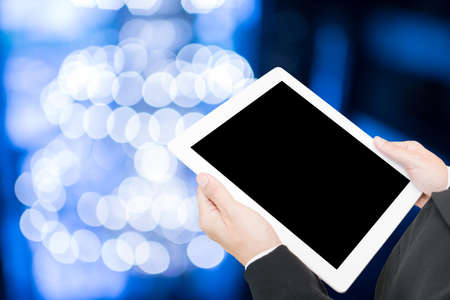 hand hold computer tablet on blur background