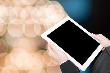 hand hold computer tablet on blur backgroundの写真素材
