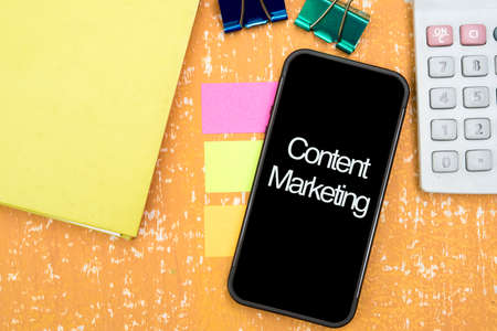 smart phone on the vintage table with word content marketingの写真素材