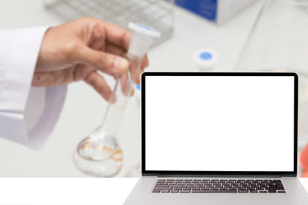 computer with blank screen and blur picture of pharmacy lab in backgroundの写真素材
