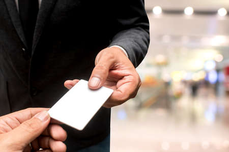 hand with name card with blur backgroundの写真素材