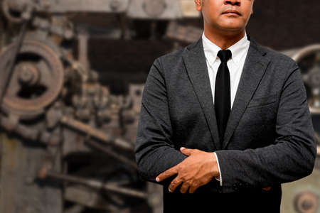 businessman standing with machine in backgroundの写真素材