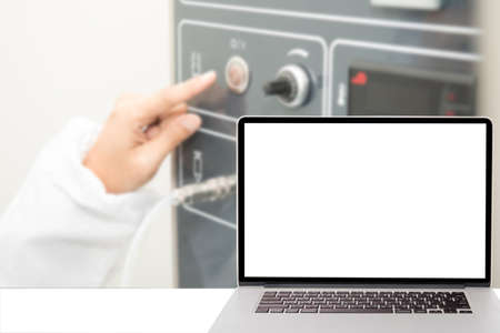 computer with blank screen and blur picture of pharmacy lab in background