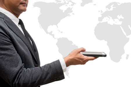 business man hold smart phone with wolrd mapの写真素材
