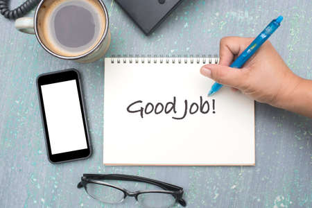 hand writing on note book with word good jobの写真素材