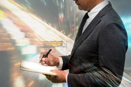 business man hold pen double exposure with beautiful backgroundの写真素材
