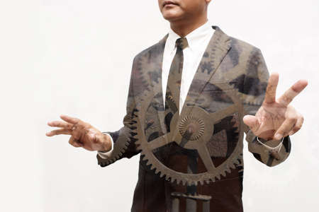 business man show hand double exposure with industrial machineの写真素材
