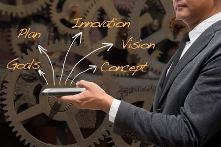business man standing with black background and words with arrows