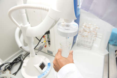 Scientist hand working at pharmacy microbiology laboratory