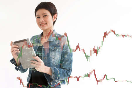 Trading Business woman hold smart device .and Forex Trading Line Graphsの写真素材