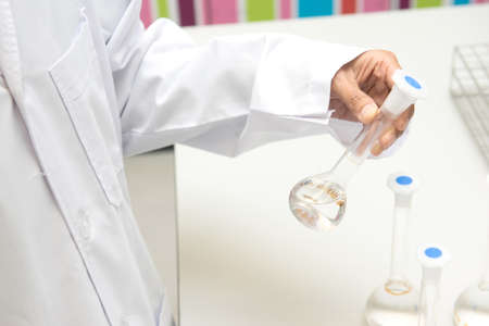 Scientist hand working at pharmacy microbiology laboratory