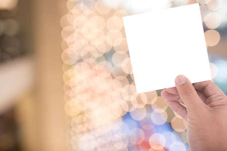 one hand hold blank card on blur backgroundの写真素材