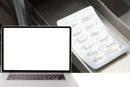 computer with blank screen on detail of pharmaceutical factoryの写真素材