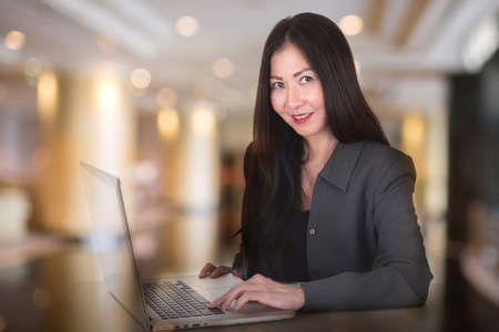 business woman with blur hall way backgroundの写真素材