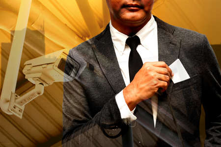 business man with name card composite with city light background double exposure with cctv cameraの写真素材