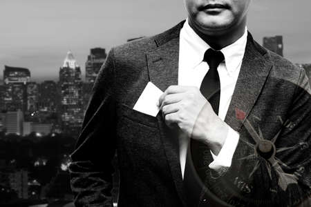 business man with name card composite with city light background double exposure with compass with black and white filterの写真素材
