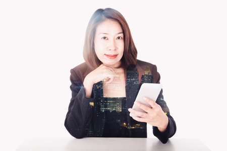 business woman hold smart phone double exposure cith cityの写真素材