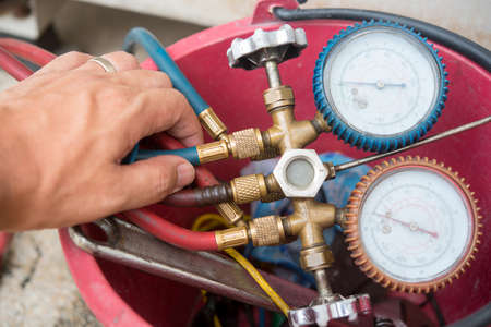 Air Conditioning Technician install new air conditioner.の写真素材