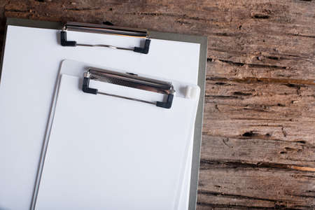 clipboard with blank paper on  wood table