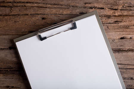 clipboard with blank paper on  wood tableの写真素材