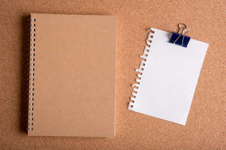 blank torn paper and blank note book on wooden tableの写真素材