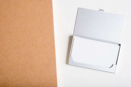 blank name card in case and blank note book on white tableの写真素材