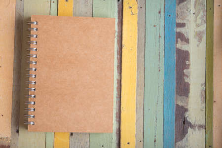 note book on colorful wooden tableの写真素材
