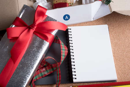 blank page book and holiday decoration on wood tableの写真素材