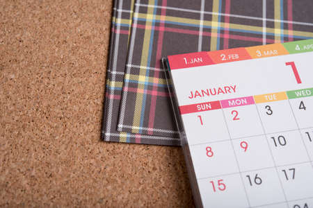 calendar and colorful paper on wood table 