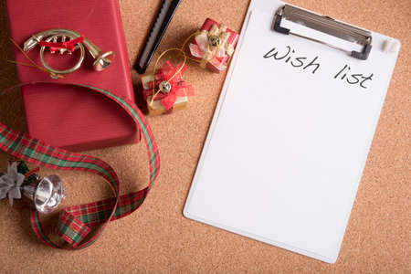 note pad with word wish list with holiday decoration on wood tableの写真素材
