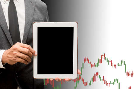 business man holding computer tablet with business graphの写真素材
