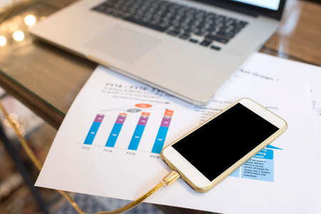smart phone with business print out documentの写真素材