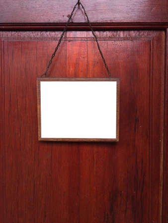 blank sign hanging at old wooden wallの写真素材