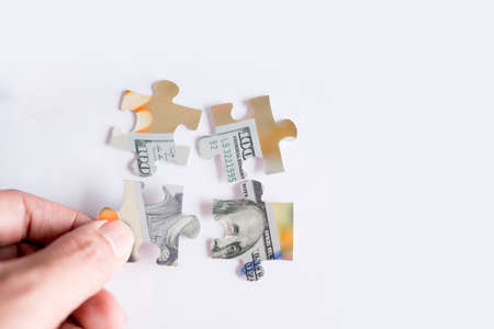 jigsaw puzzle with image of one hundred dollar bank noteの写真素材