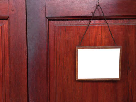 blank sign hanging at old wooden wallの写真素材