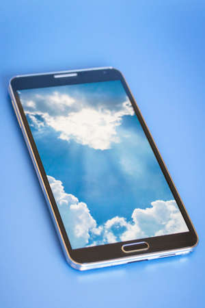 isolated smartphone, showing cloud computing concept on screen, blue backgroundの写真素材