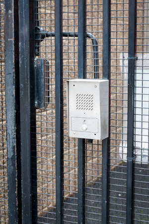 Security intercom on locked meatl gatesの写真素材