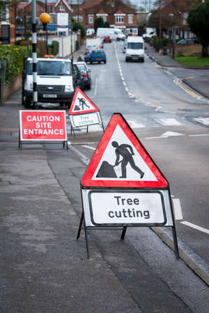 Tree cutting sign, on British town streetの写真素材