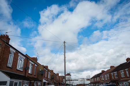 Mess of overhead  telephone wiring in British town streetの写真素材