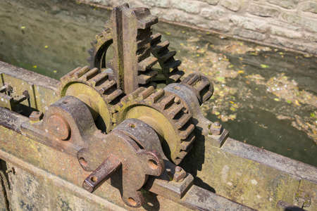 Vintage iron gear wheels on canal lock gate in Ludlow, England.の写真素材