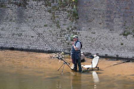 Bridgnorth, UK - 19 June, 2014: Fisherman seen at side of river.のeditorial素材