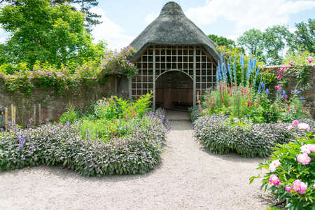 Thatched gazebo in a traditional English garden.のeditorial素材