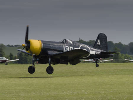 Duxford, UK - May 23rd 2015: A vintage US Chance Vought Corsair aircraft, flying at Duxford VE Day Airshowのeditorial素材